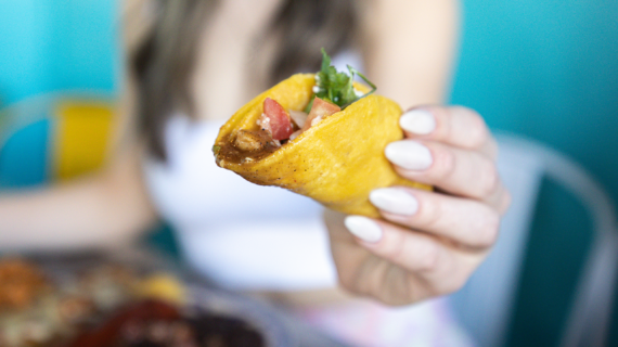 girl holding taco